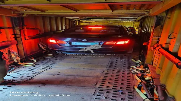 Premium sedan secured inside closed car carrier in Vadodara